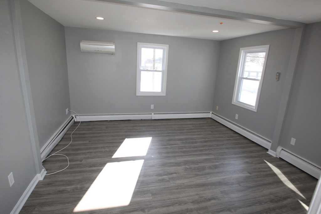 299 Main Street, Unit 2 North Reading, MA 01864 - Photo 33 of 35 wooden floor in an empty room with a window