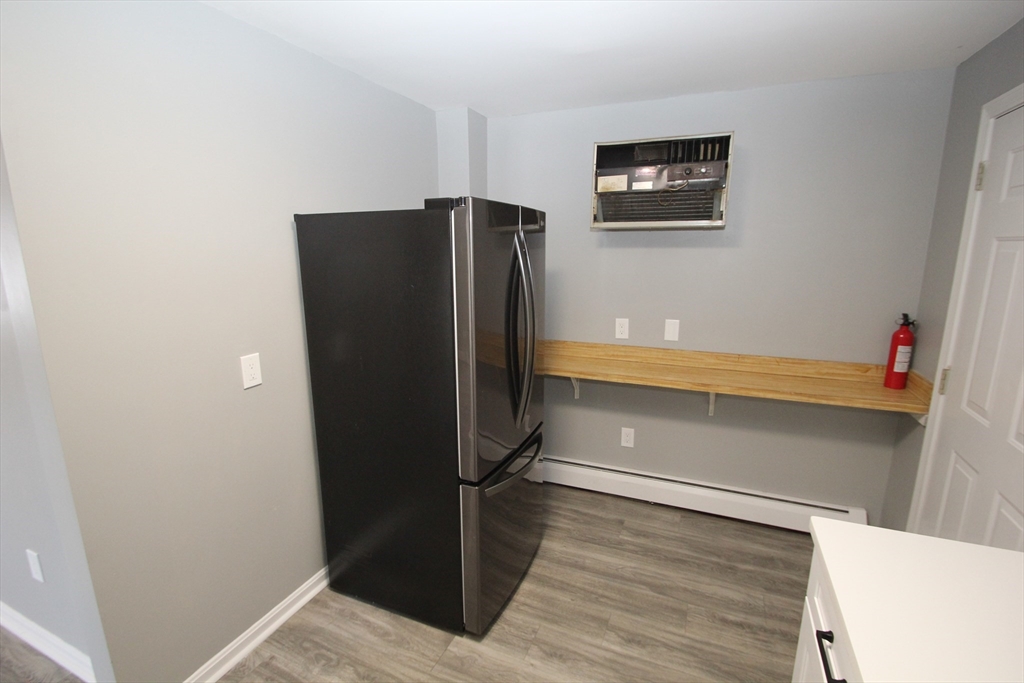 299 Main Street, Unit 2 North Reading, MA 01864 - Photo 9 of 35 a view of walk in closet with wooden floor