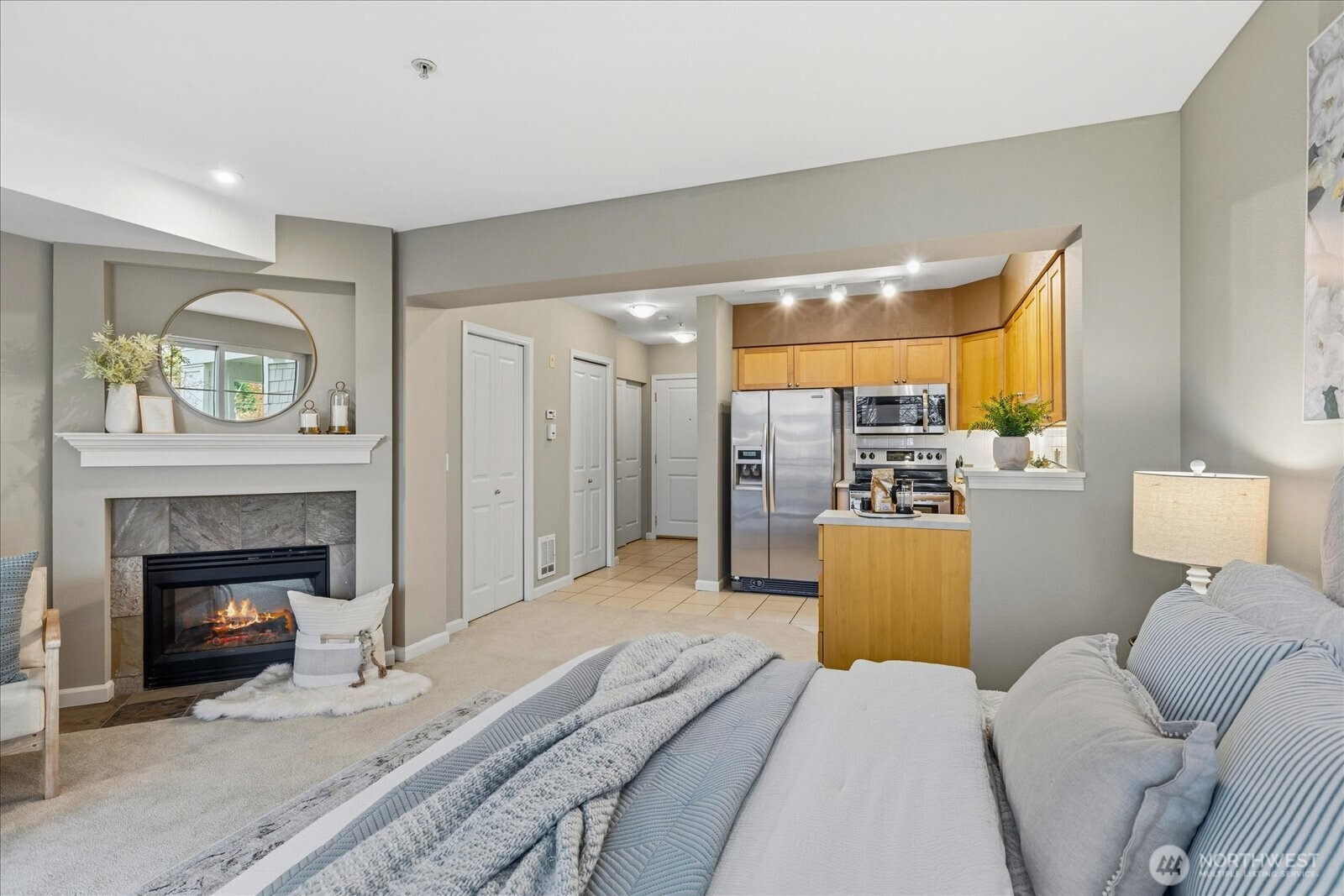 1525 Northwest 57th Street, Unit 429 Seattle, WA 98107 - Photo 14 of 26 a bedroom with a bed and a fireplace