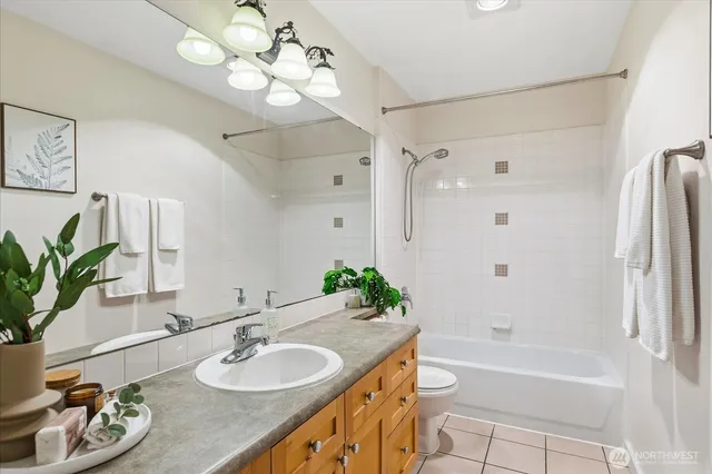 a bath room with a granite countertop sink and a mirror