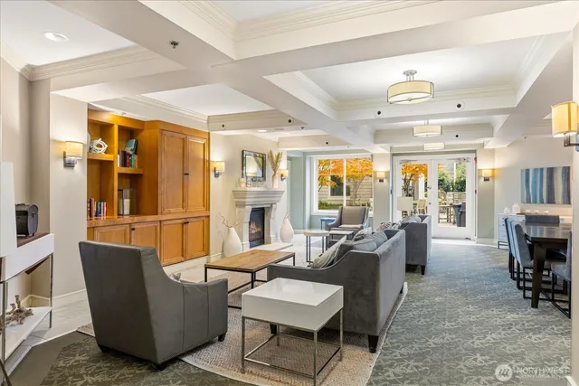 a living room with furniture and a view of kitchen