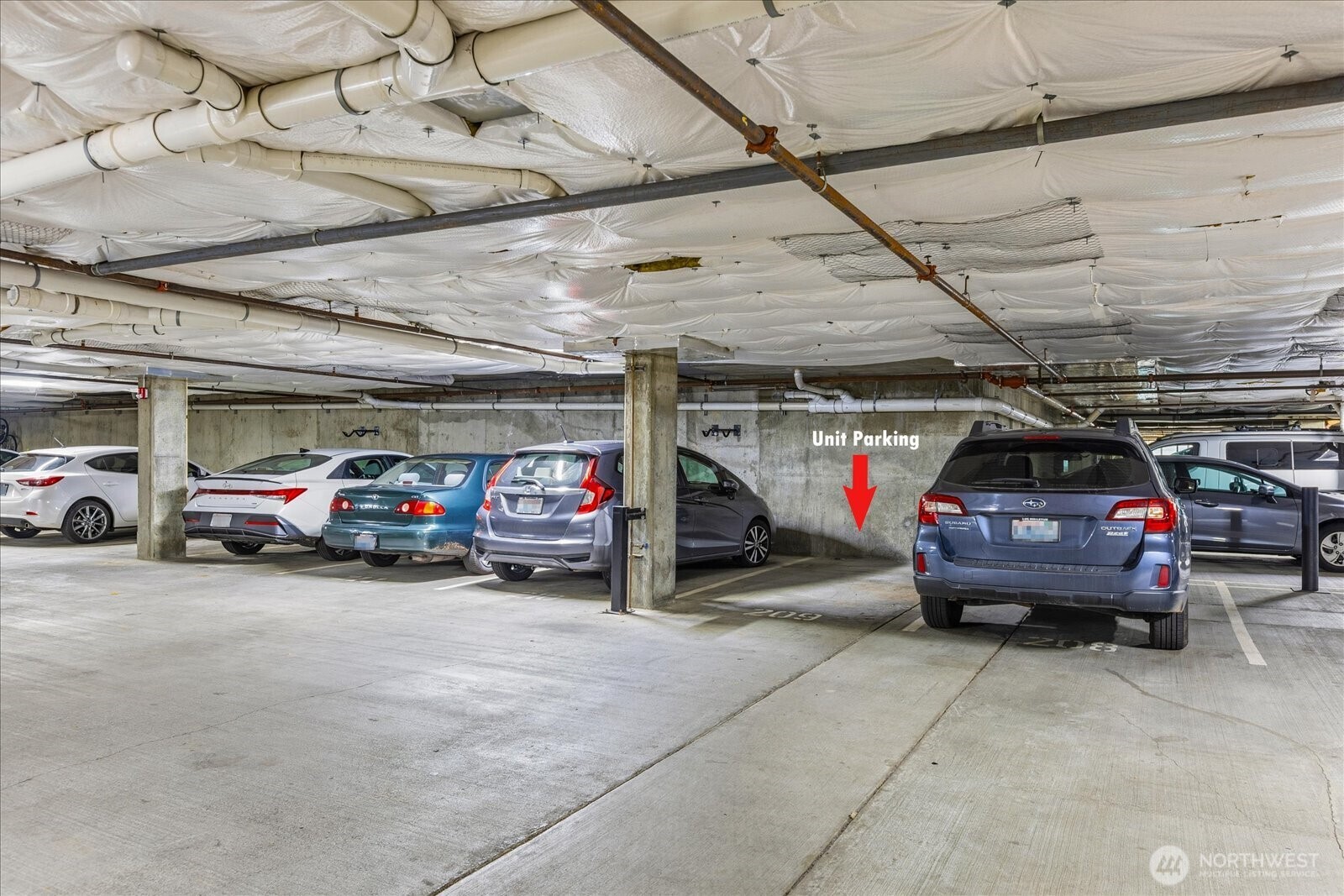 1525 Northwest 57th Street, Unit 429 Seattle, WA 98107 - Photo 25 of 26 a view of parking garage with cars parked