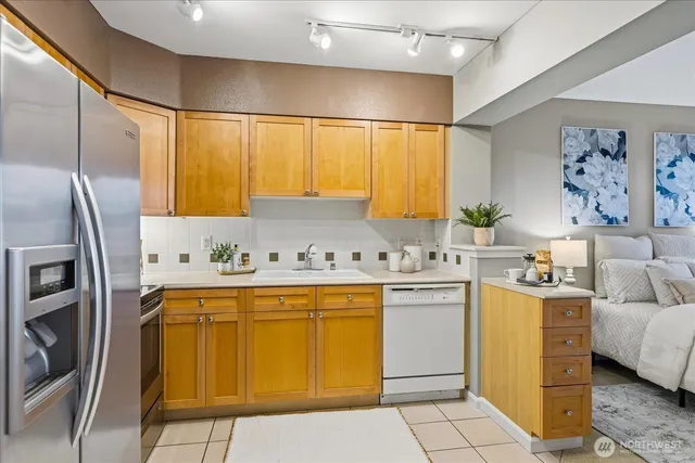 a kitchen with a sink appliances and cabinets