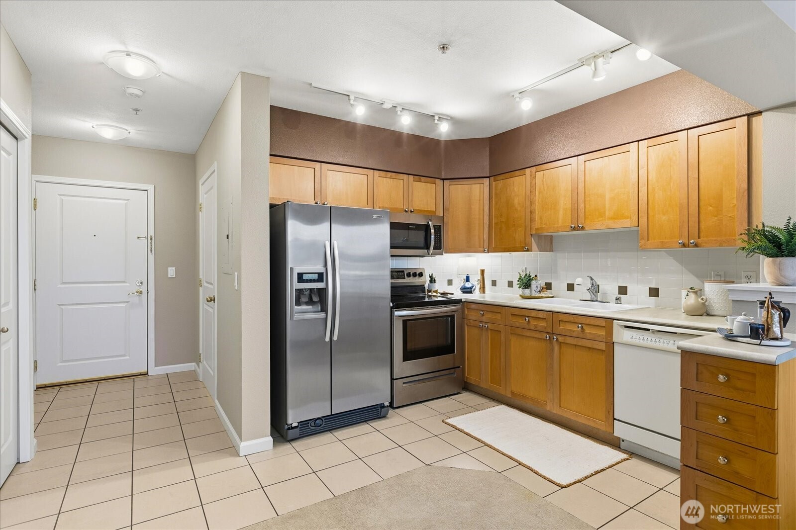 1525 Northwest 57th Street, Unit 429 Seattle, WA 98107 - Photo 8 of 26 a kitchen with stainless steel appliances granite countertop a refrigerator and a sink
