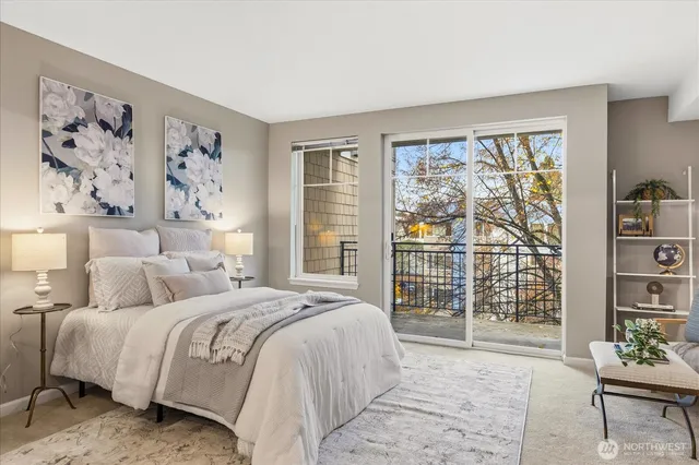 a bedroom with a large bed and a window with the outer view