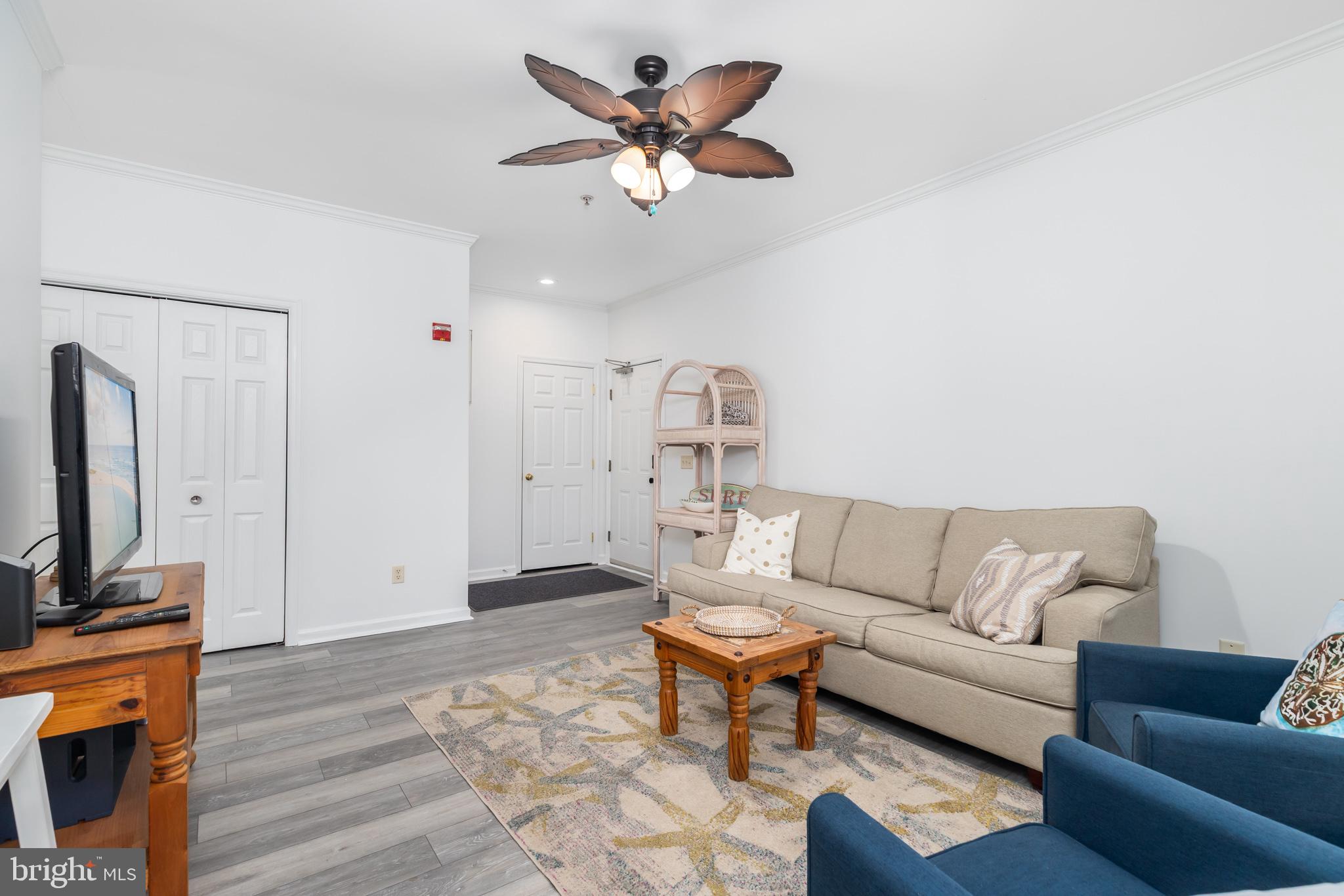 200 Pebble Drive, Unit 207 Rehoboth Beach, DE 19971 - Photo 2 of 7 a living room with furniture and a flat screen tv