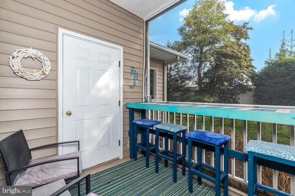 a view of a chair and table on the deck