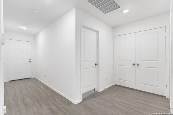 a view of an empty room with wooden floor