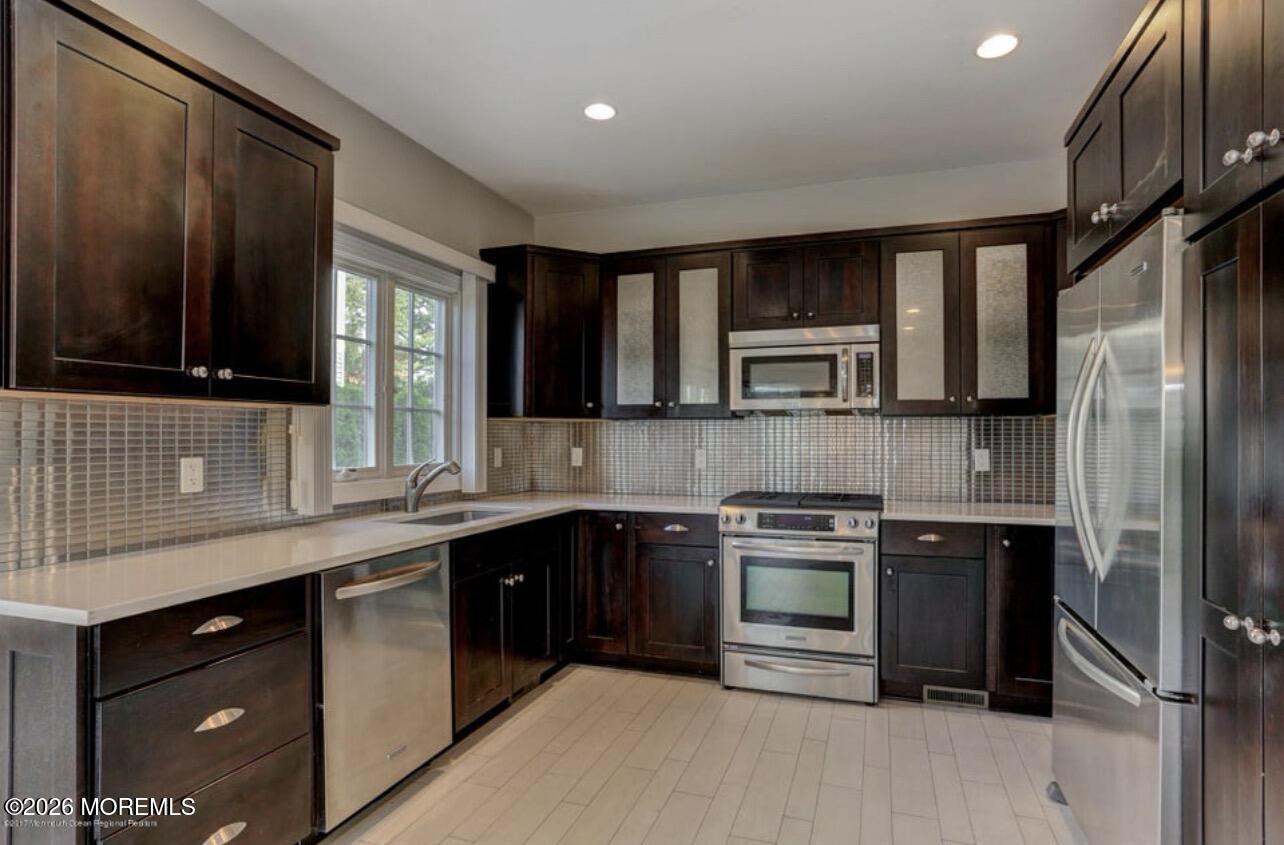 1-3 Church Street Matawan, NJ 07747 - Photo 2 of 28 a kitchen with a sink stove and cabinets