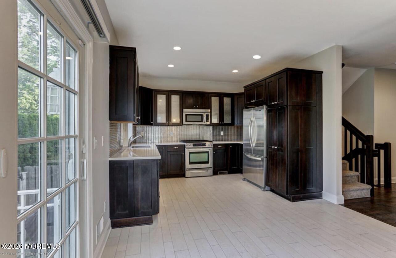 1-3 Church Street Matawan, NJ 07747 - Photo 26 of 28 a kitchen with stainless steel appliances kitchen island granite countertop a refrigerator and a sink