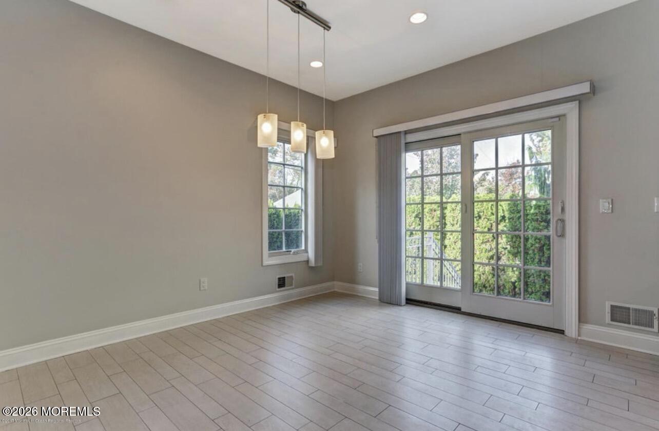 1-3 Church Street Matawan, NJ 07747 - Photo 28 of 28 a view of an empty room with wooden floor and a window