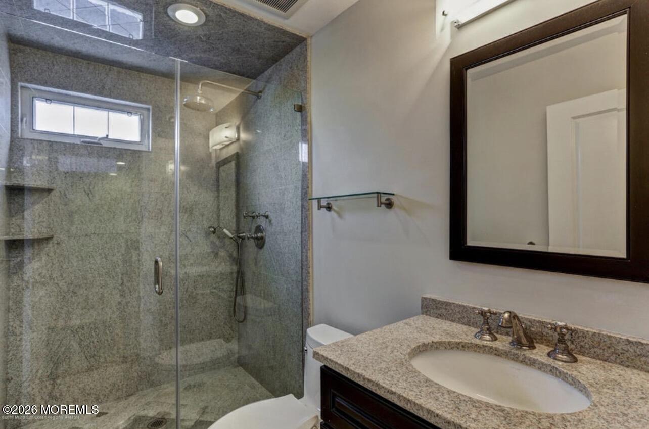 1-3 Church Street Matawan, NJ 07747 - Photo 8 of 28 a bathroom with a granite countertop sink mirror and shower