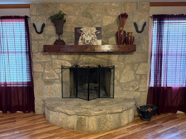 a view of fireplace and wooden floor