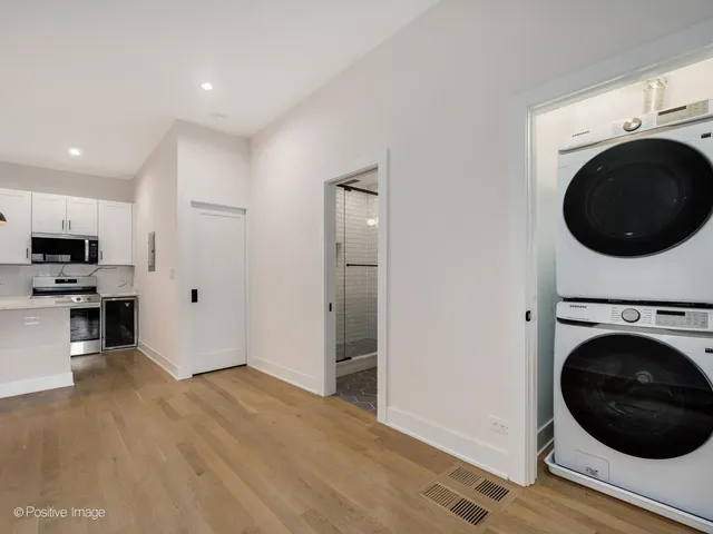 a view of a kitchen with a washer and dryer