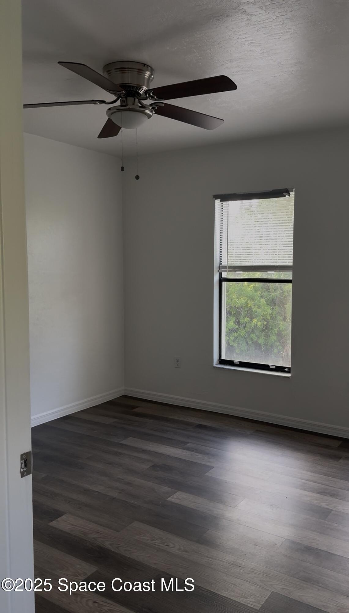 1971 Agora Circle Southeast, Unit 101 Palm Bay, FL 32909 - Photo 4 of 5 a view of room with window and hardwood floor