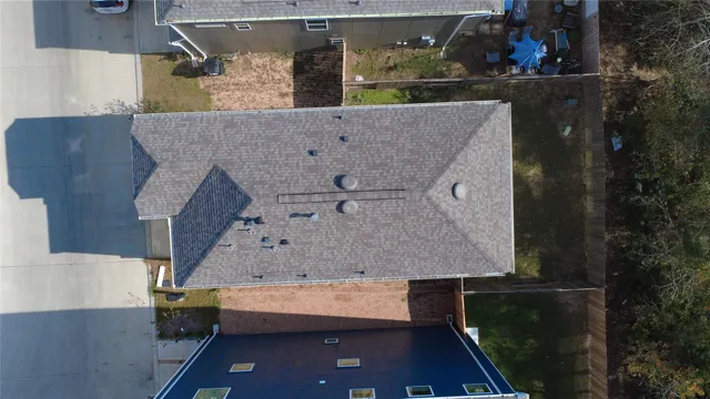 an aerial view of a house with a yard