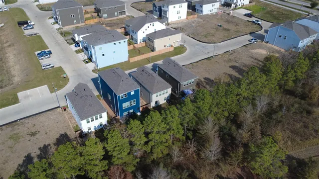 an aerial view of a house with garden space and street view