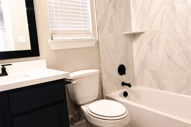 a bathroom with a sink a toilet and a bathtub