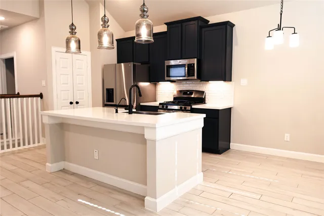 a kitchen with a sink microwave and refrigerator