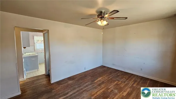 a view of an empty room with wooden floor