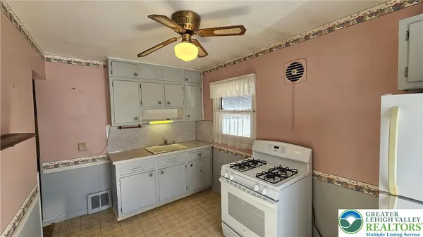 a kitchen with a stove a sink and a refrigerator