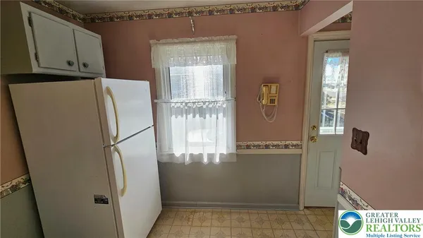 a white refrigerator freezer and a table in a kitchen
