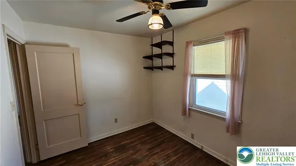 a view of a hallway with wooden floor and stairs