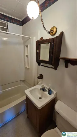 a bathroom with a toilet sink and mirror