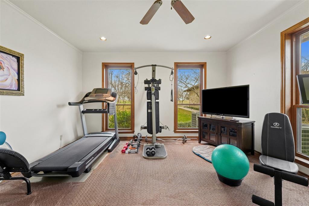 9711 Jim Christal Road Krum, TX 76249 - Photo 26 of 38 a room with furniture and a flat screen tv