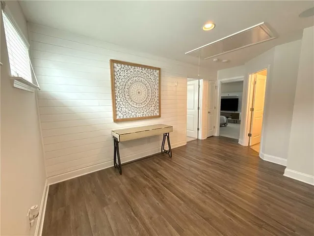 a view of a room with wooden floor and furniture