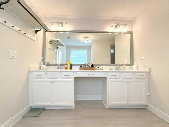 a bathroom with a sink vanity and mirror