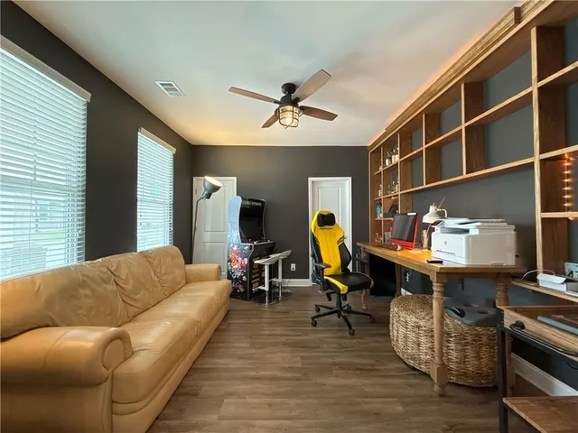 a living room with furniture a piano and a window