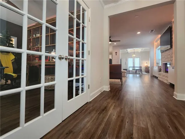 a view of a big room with wooden floor and windows