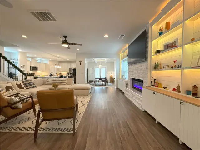 a living room with furniture and kitchen view