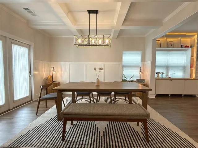 a view of a dining room with furniture wooden floor and chandelier
