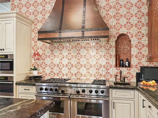 a stove top oven sitting inside of a kitchen