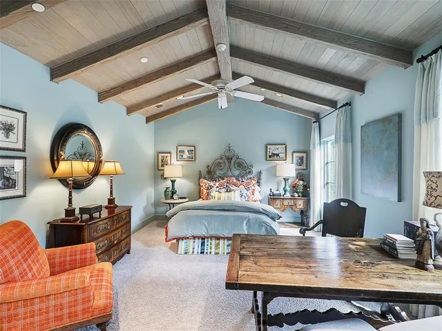 a living room with furniture a rug and a chandelier