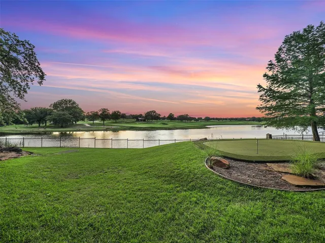 a view of a lake with houses in the back