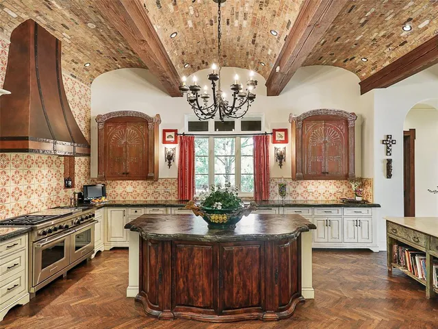 a kitchen with a stove a sink and cabinets