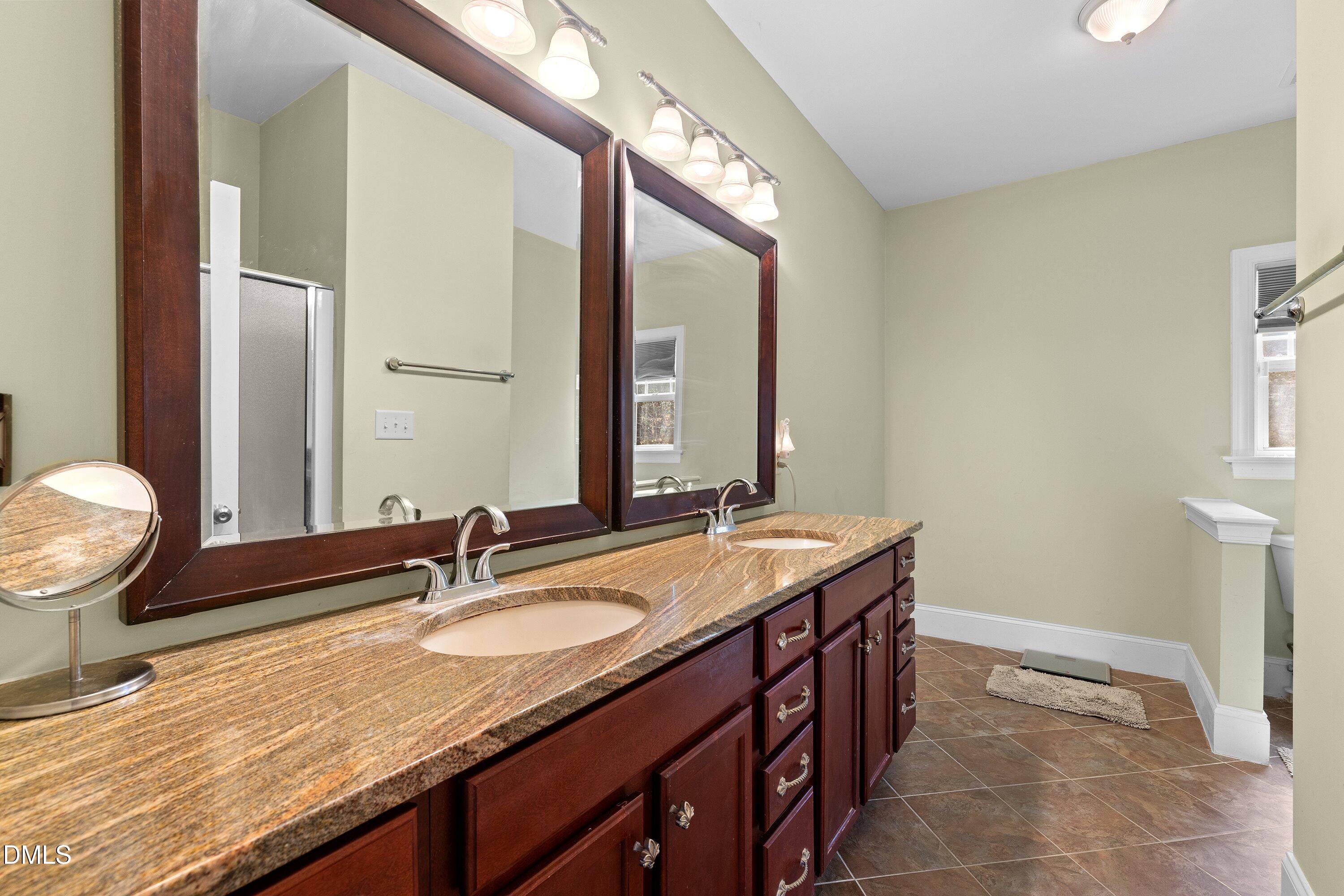 9713 Lake Wheeler Road Raleigh, NC 27603 - Photo 6 of 18 a bathroom with a granite countertop sink and a mirror