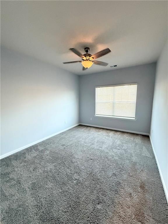 247 Centennial Circle Canton, GA 30114 - Photo 13 of 25 an empty room with a window and a fan