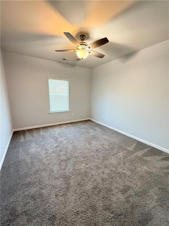 247 Centennial Circle Canton, GA 30114 - Photo 16 of 25 an empty room with a ceiling fan and window