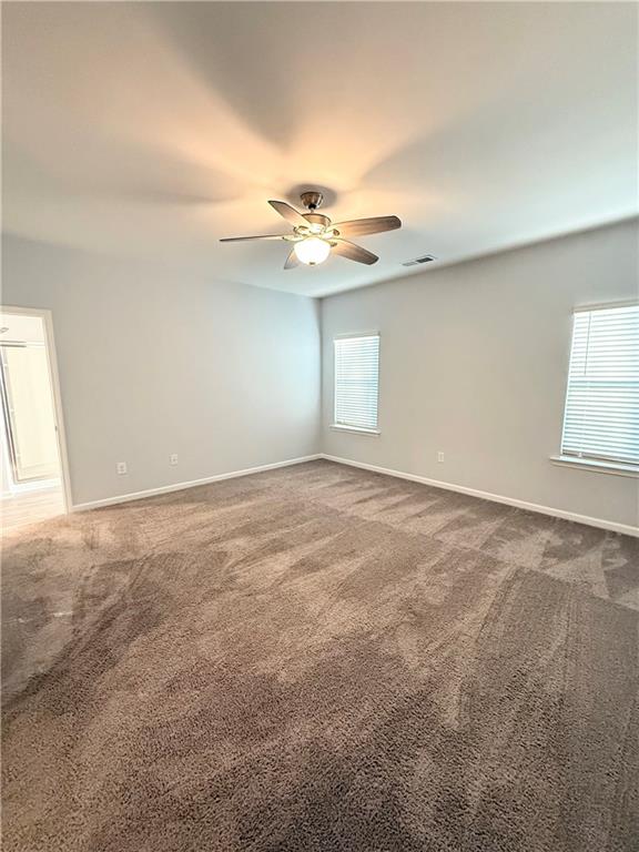 247 Centennial Circle Canton, GA 30114 - Photo 21 of 25 an empty room with windows and ceiling fan view