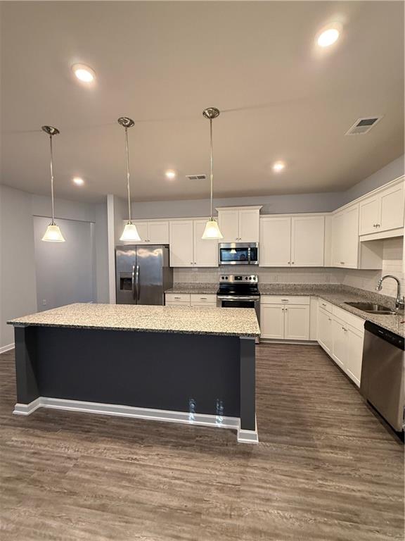 247 Centennial Circle Canton, GA 30114 - Photo 6 of 25 a view of kitchen with stainless steel appliances granite countertop a stove a sink a refrigerator and a island