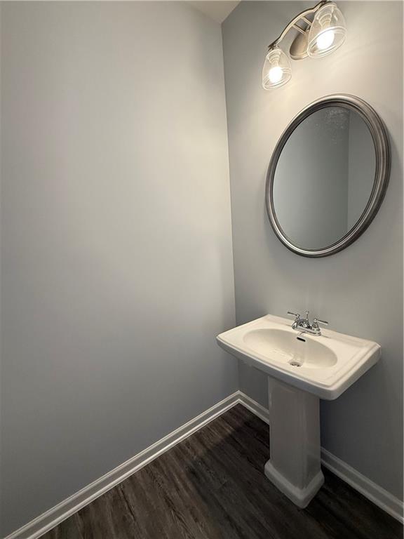 247 Centennial Circle Canton, GA 30114 - Photo 10 of 25 a bathroom with a sink a mirror and a toilet