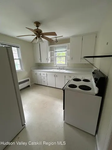 a kitchen with a sink a stove and cabinets