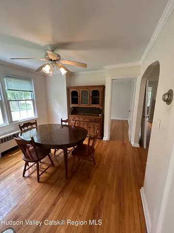 a view of a livingroom with furniture window and wooden floor