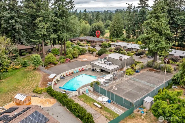 an aerial view of a house with a garden and lake view