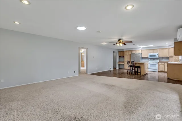 a view of an empty room with kitchen