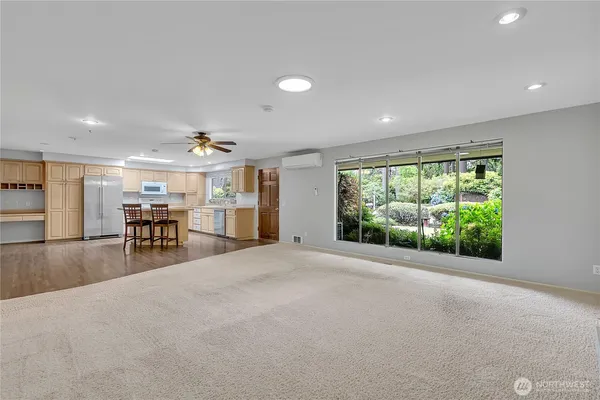 a view of a livingroom with furniture and a large window